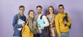 Diverse group of happy, smiling university or college friends with backpacks, books and laptops Royalty Free Stock Photo