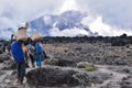 Diverse group of hikers trekking across the rugged terrain of Mount Kilimanjaro