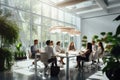 A diverse group of individuals sitting around a table engaged in a lively discussion and working together on a shared project, Royalty Free Stock Photo