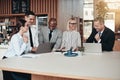 Diverse group of laughing businesspeople working in an office Royalty Free Stock Photo