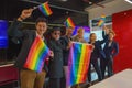 Diverse group of lgbtq people with rainbow flag on hand team up together