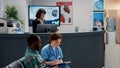 Diverse group of patients asking for help at hospital reception desk Royalty Free Stock Photo