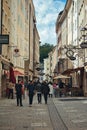 Diverse group of pedestrians navigating their way through a bustling urban landscape in Salzburg.