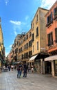 Diverse group of people in the bustling street of vibrant Venice city, creating a lively scene