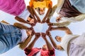 Diverse group of people in circle joining hands together outdoors Royalty Free Stock Photo