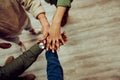 Diverse group of people gathering to stack hands showing unity and teamwork working together for big project Royalty Free Stock Photo