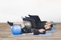 Diverse group of people in a gym class lying in a receding row o Royalty Free Stock Photo