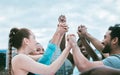 Diverse group of people holding hands with arms raised to express unity, support and trust. Motivated athletes cheering Royalty Free Stock Photo