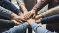 Diverse group of people putting hands together in a huddle symbolizing teamwork and unity Royalty Free Stock Photo