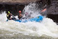 Diverse group of people rafting together in a flowing river