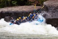 Diverse group of people rafting together in a flowing river