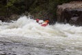 Diverse group of people rafting together in a flowing river