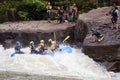 Diverse group of people rafting together in a flowing river