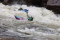 Diverse group of people rafting together in a flowing river