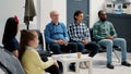 Diverse group of people sitting together in hospital waiting room Royalty Free Stock Photo