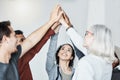 Diverse group of people standing together in circle and raising their hands in middle after therapy for a high five Royalty Free Stock Photo