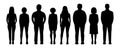 Diverse group of people standing together in silhouette representing unity and teamwork in a community or organization against a Royalty Free Stock Photo