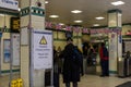 Diverse group of people with suitcases waiting in a busy train station