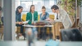Diverse Group of People Talking in a Casual Modern Meeting Room in Office Using Laptop Computer Royalty Free Stock Photo