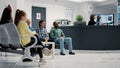 Diverse group of people waiting in hospital reception lobby Royalty Free Stock Photo