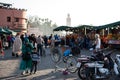 Diverse group of people walking down a street market in Marrakech, Morocco