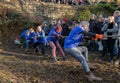 Diverse group of people working together to pull a rope during a game