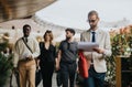 Group of business professionals walking outdoors with work materials Royalty Free Stock Photo