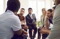 Diverse group of serious business people discussing something during meeting in office Royalty Free Stock Photo