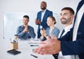 Diverse group of smiling business people clapping during boardroom meeting in office. Happy team of male and female Royalty Free Stock Photo