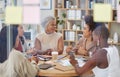 Diverse group of smiling business women having a brainstorm meeting in office. Happy confident professional team sitting Royalty Free Stock Photo