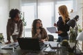 Diverse group of smiling business women having a break in office talking