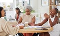 Diverse group of smiling business women planning a brainstorm meeting in office. Happy confident professional team Royalty Free Stock Photo