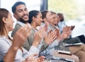 Diverse group of smiling businesspeople clapping in office training. Team of professional colleagues cheering and Royalty Free Stock Photo