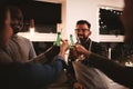 Laughing friends toasting with drinks during a dinner party Royalty Free Stock Photo