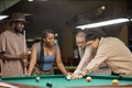 Diverse Group of Smiling People Playing Pool Together Royalty Free Stock Photo