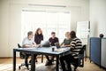 Smiling design colleagues talking together during an office meet