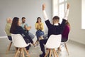 Diverse group therapy members applauding happy young man who overcame his addiction Royalty Free Stock Photo