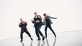 Diverse Group of Three Professional Dancers Performing a Hip Hop Dance Routine in Front of a Big D Royalty Free Stock Photo