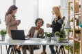 Diverse group of smiling business women having a break in office talking