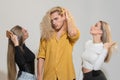 Diverse group of women and man combing hair isolated over background. Attractive cheerful sexy, fashionable group models Royalty Free Stock Photo