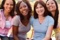 Diverse group of women talking and laughing.