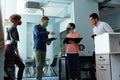 Diverse group of work colleagues wearing masks in discussion office Royalty Free Stock Photo