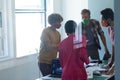 Diverse group of work colleagues wearing masks in an office Royalty Free Stock Photo