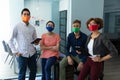 Diverse group of work colleagues wearing masks in an office Royalty Free Stock Photo