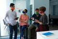 Diverse group of work colleagues wearing masks talking together Royalty Free Stock Photo