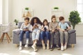 Group of multiethnic kids playing online games on mobile phones and ignoring real life Royalty Free Stock Photo