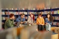Diverse Group of Young Adults Collaborating during Study Session in Library Royalty Free Stock Photo