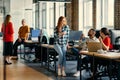 A diverse group of young business individuals congregates in a modern startup coworking center, embodying collaborative Royalty Free Stock Photo