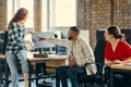 A diverse group of young business individuals congregates in a modern startup coworking center, embodying collaborative Royalty Free Stock Photo