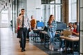 A diverse group of young business individuals congregates in a modern startup coworking center, embodying collaborative Royalty Free Stock Photo